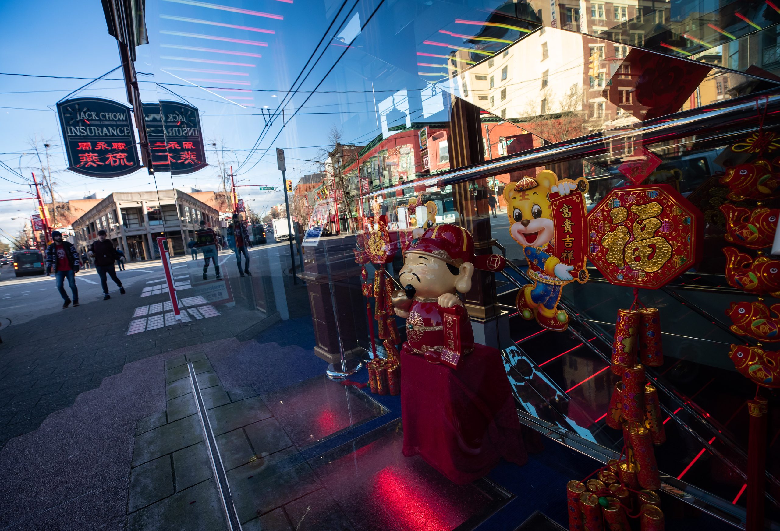 People walk past a Chinese New Year window display in the Jack Chow Insurance building in Chinatown, in Vancouver, on Tuesday, February 1, 2022. The designated heritage site measures only four feet 10 inches (1.47 metres) wide and holds the title of “World's Narrowest Commercial Building” in the Guinness Book of Records. Tuesday marks the beginning of the Lunar New Year, ushering in the year of the tiger in the Chinese zodiac