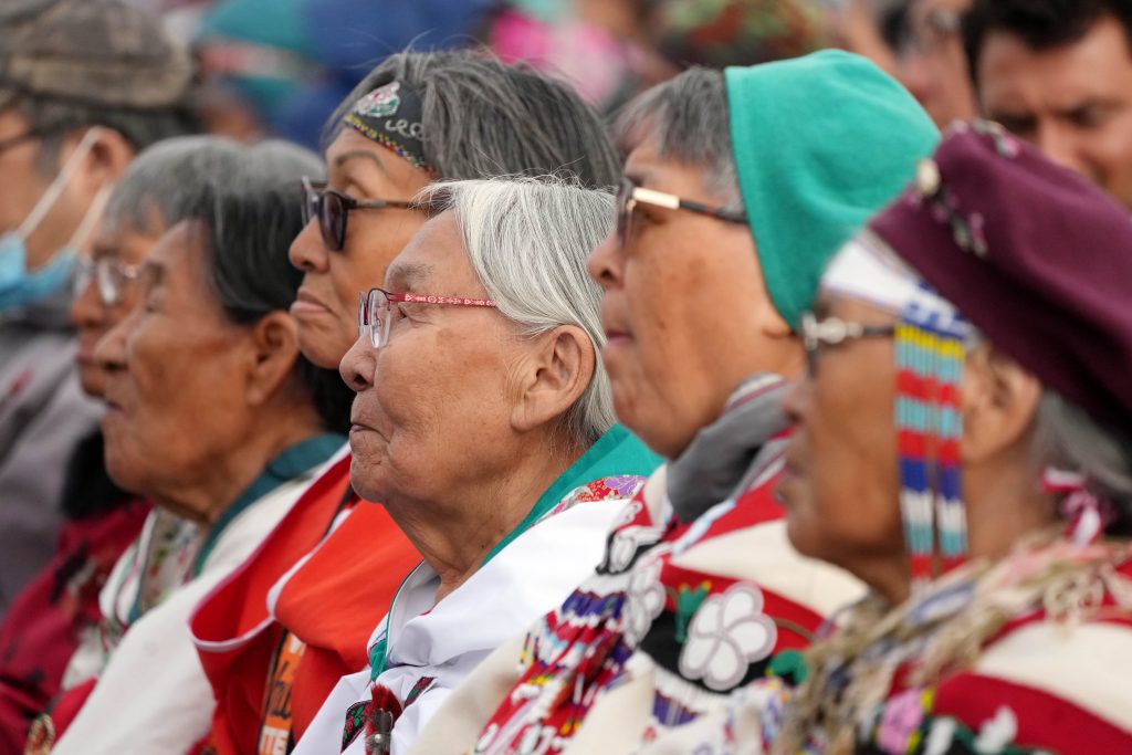 Indigenous elders listen as Pope Francis gives an apology
